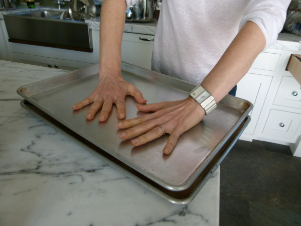 press down on the baking sheet to flatten the potatoes