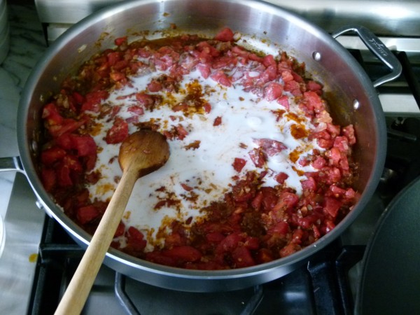 stir coconut milk into the tomato-spice mixture