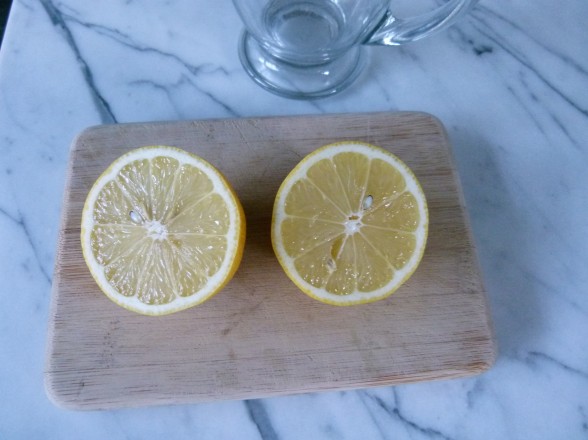 cut a washed, organic lemon in half