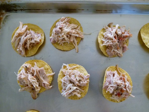 top each tortilla round with a pinch of chicken