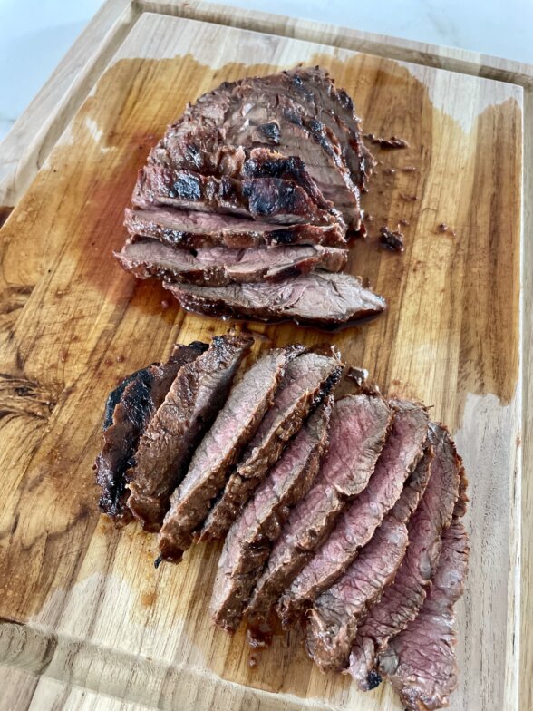 grilled flat iron steak recipe sliced on a cutting board