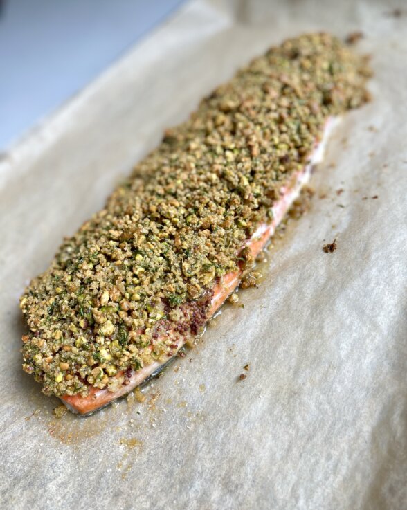 a large salmon filet topped with pistachio crust