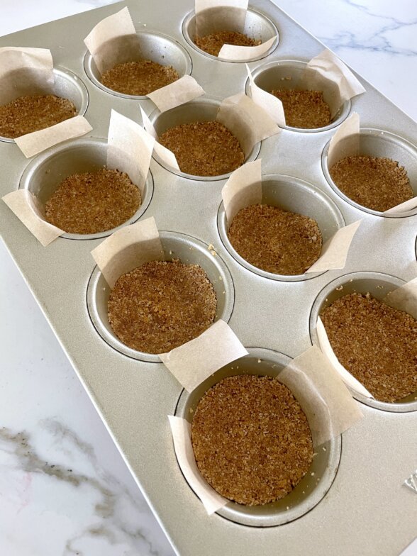 muffin cups filled with graham cracker crumbs