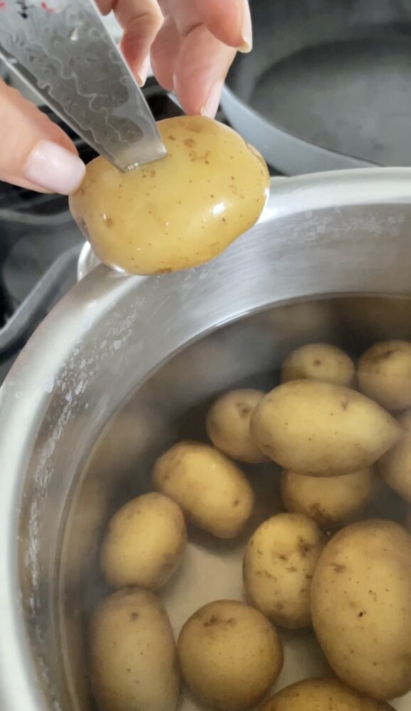 testing potato tenderness with paring knife
