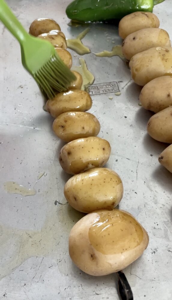 brushing potatoes with oil