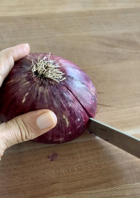 slicing red onion into quadrants