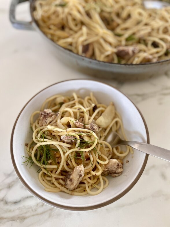 a bowl of pasta with a fork