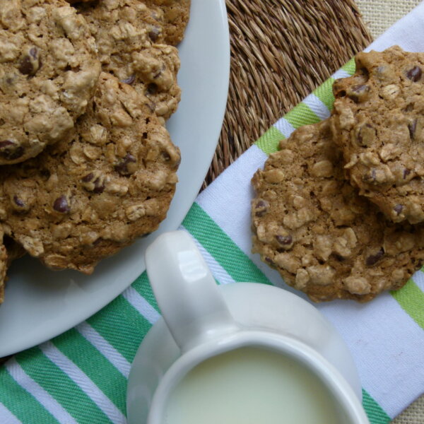 vegan oatmeal chocolate chip cookies on a plate with milk