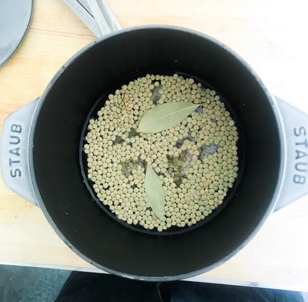 lentils cooking in a saucepan with bay leaves