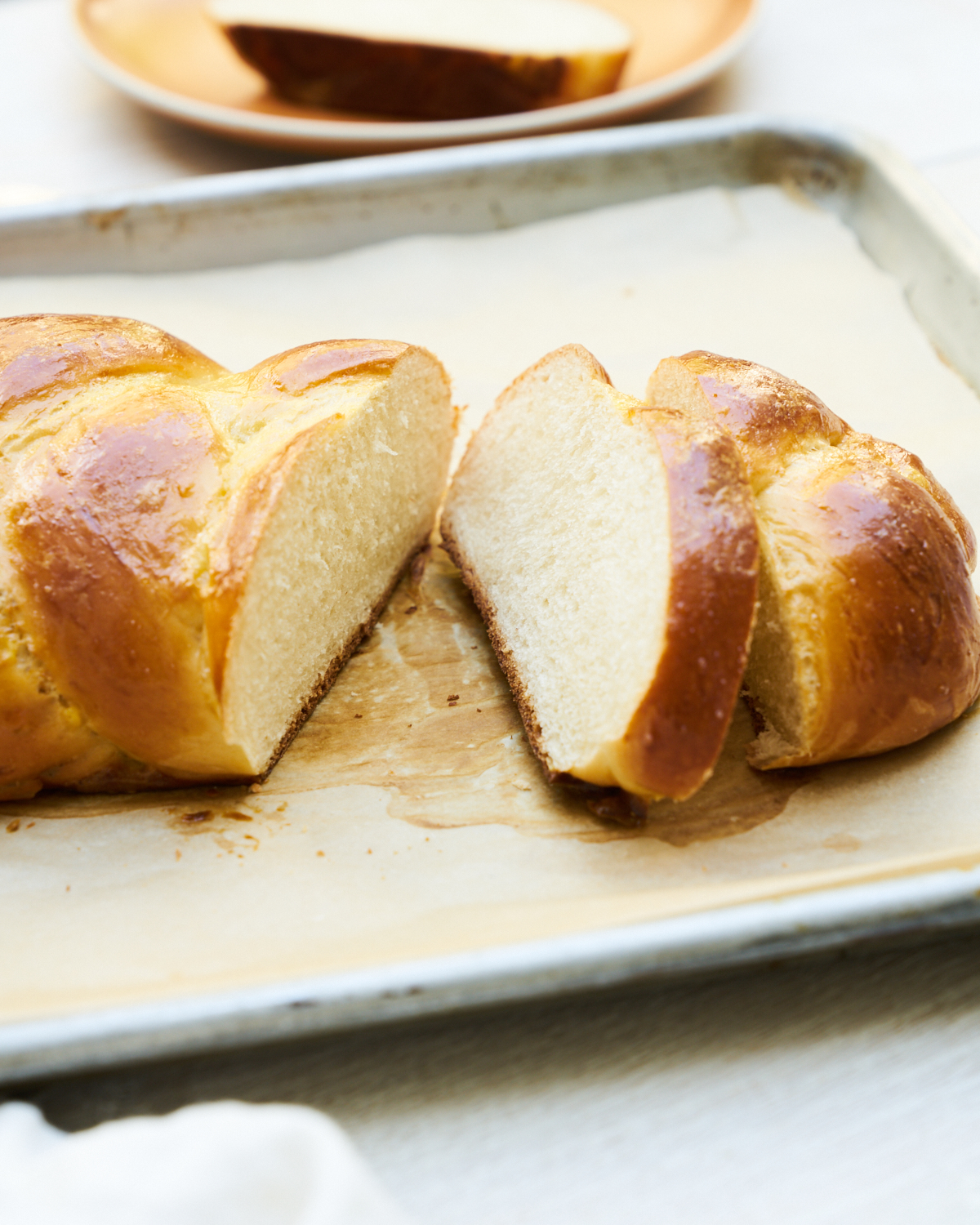 slices of challah bread on a baking sheet 