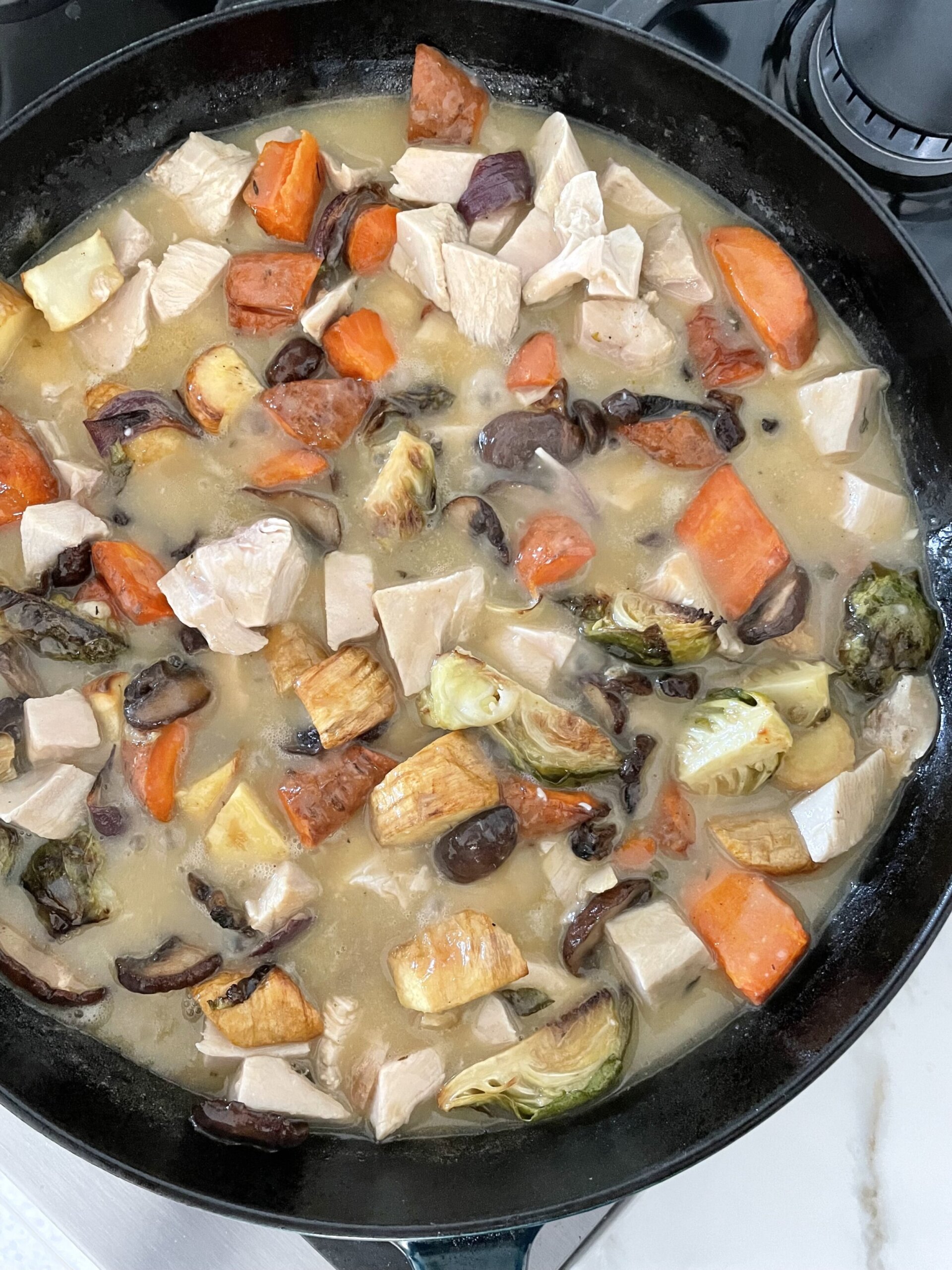 pot pie ingredients in a skillet on. astove