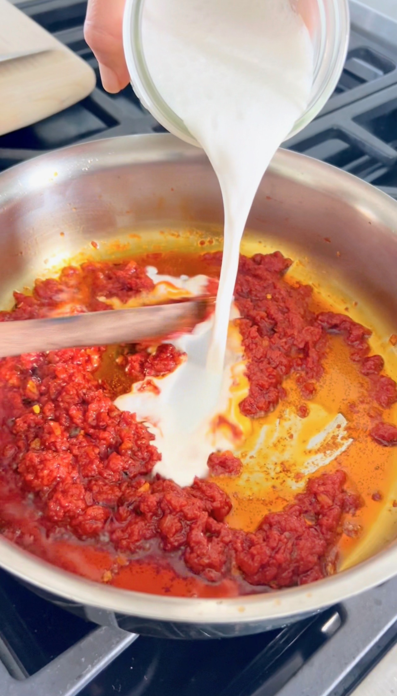 Cooking tomato paste in a pan until caramelized for vodka sauce