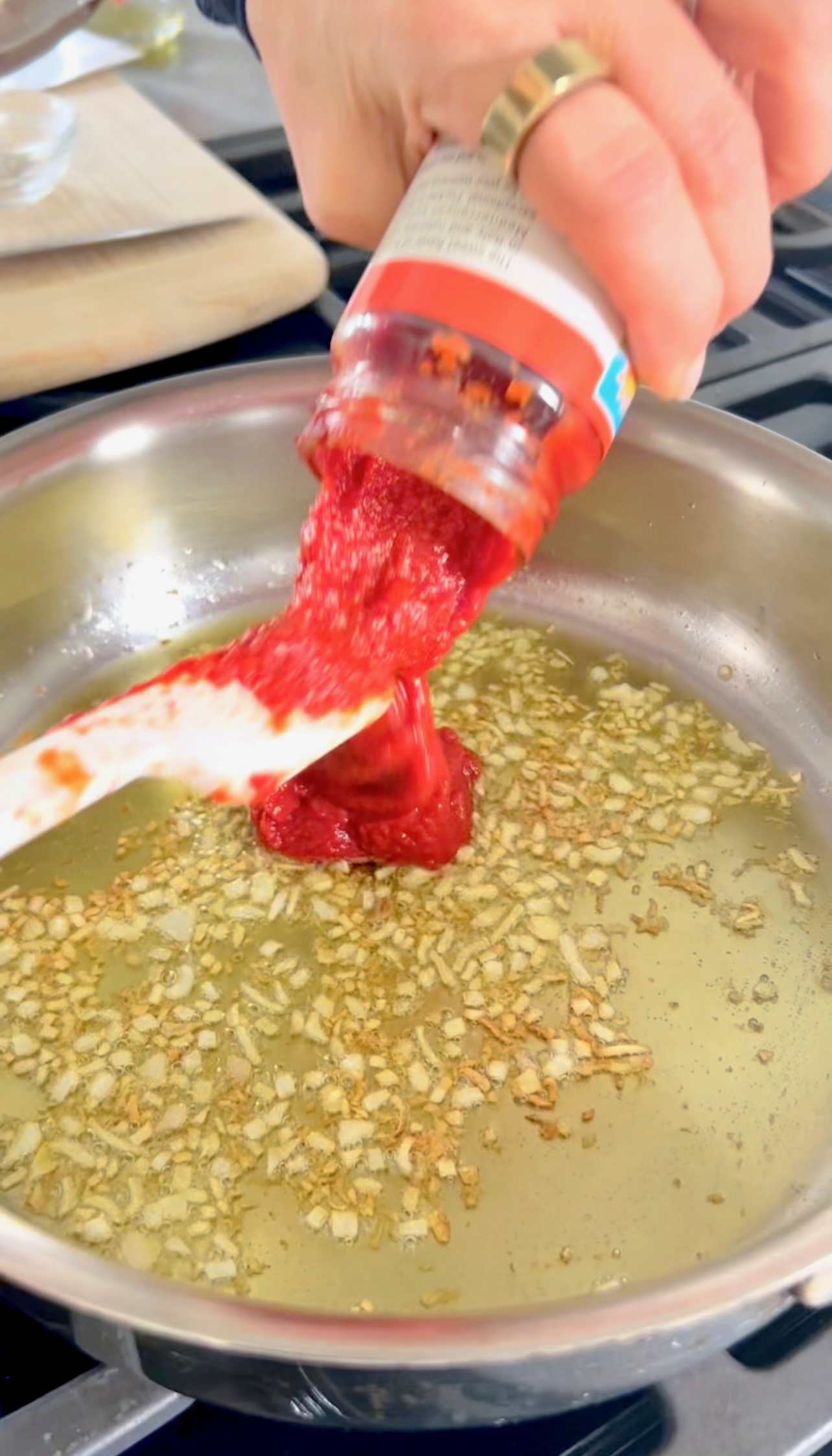 Sautéing shallots and garlic in olive oil in a stainless steel skillet