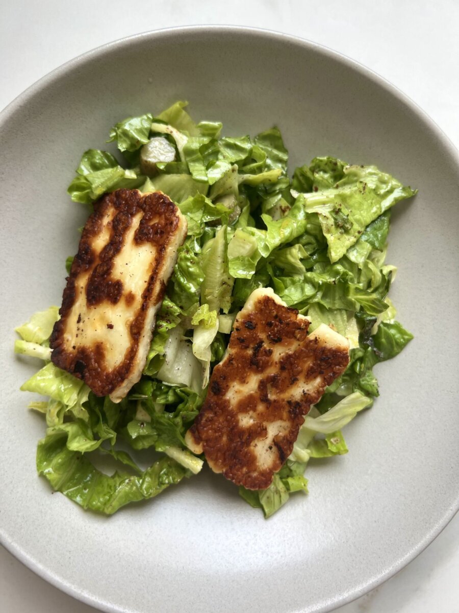 grilled halloumi salad in a white dish