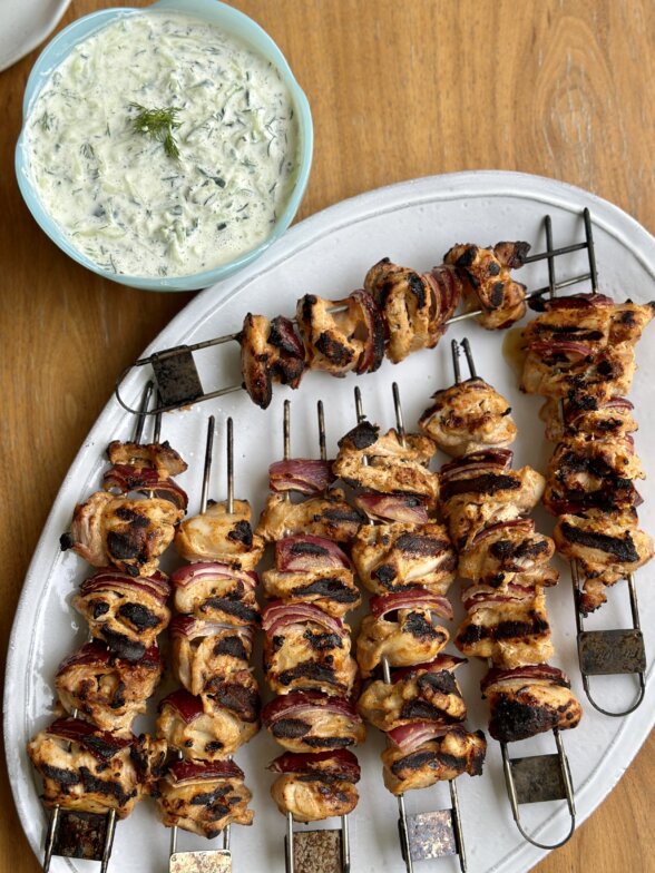chicken skewers on a white platter