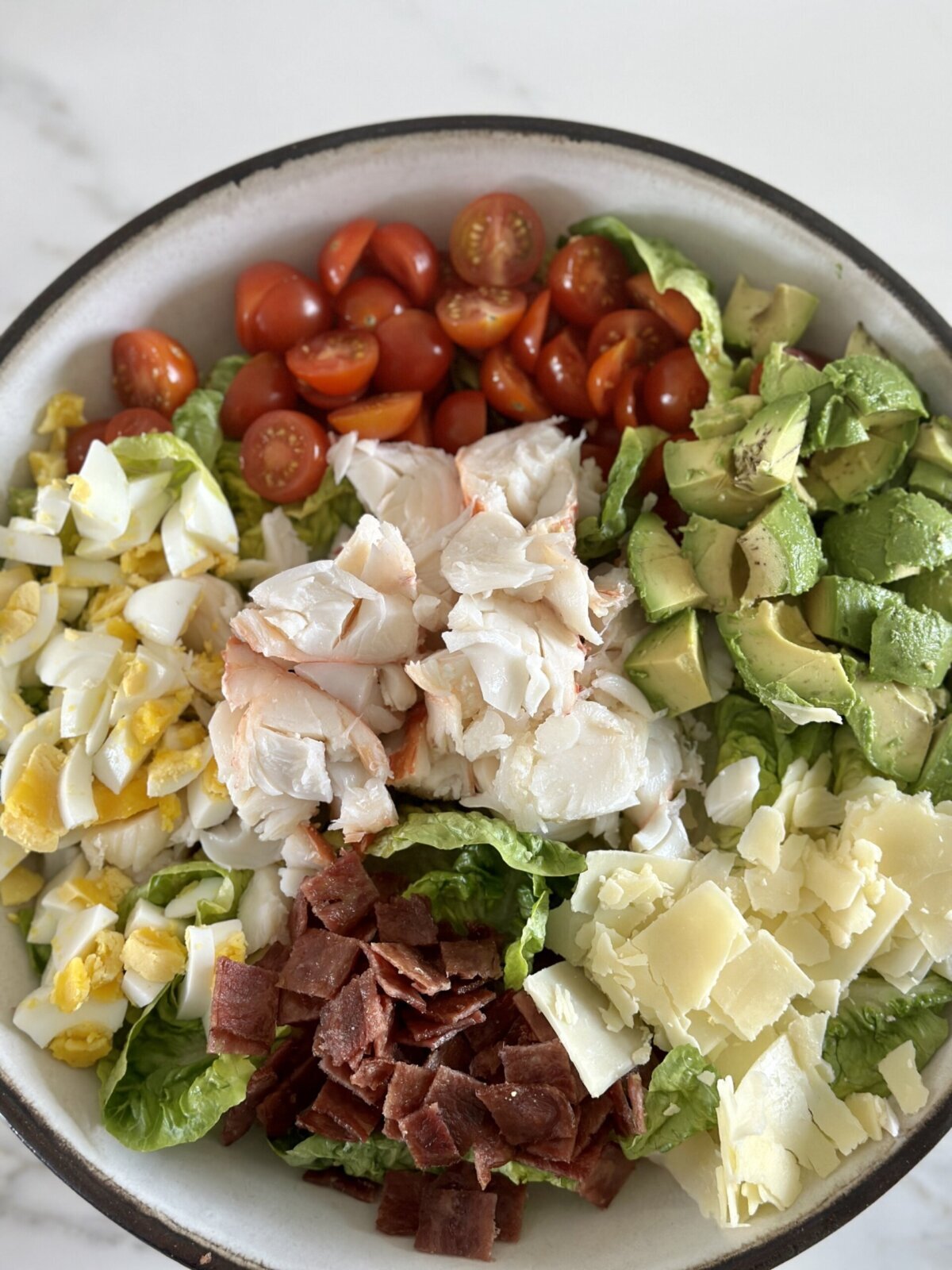 lobster cobb salad in a large mixxing bowl 