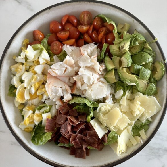 an overhead photo of lobster cobb salad in a bowl