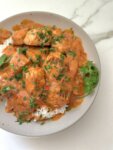 oven roasted salmon in a bowl with rice and sauce