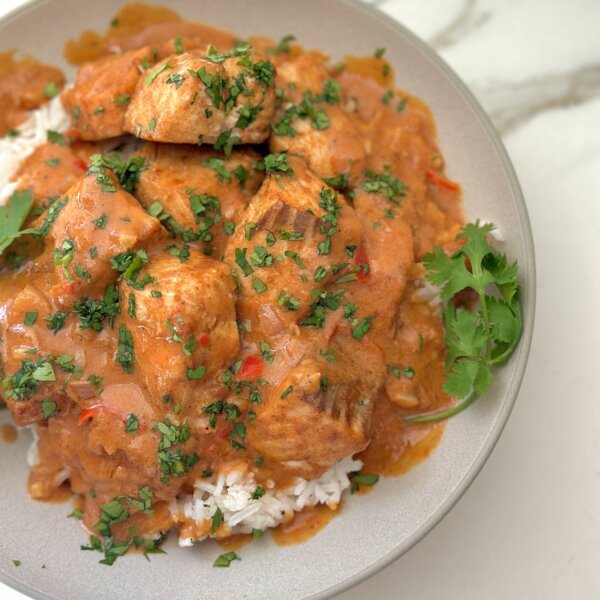 oven roasted salmon in a bowl with rice and sauce