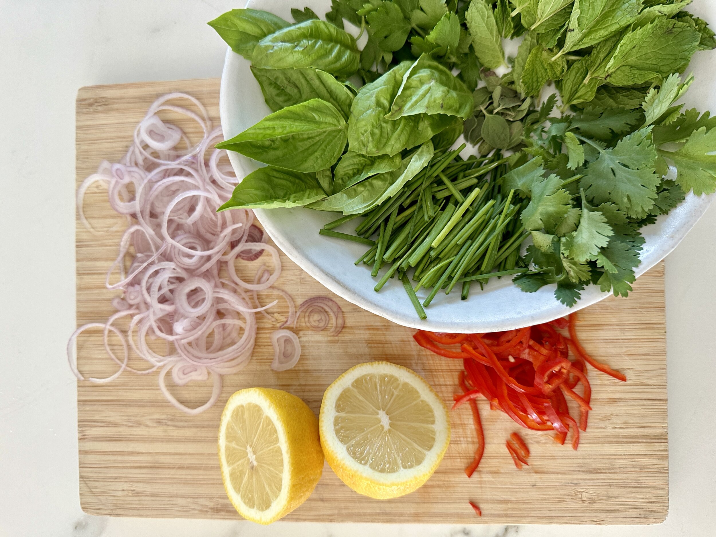 herb salad ingredients on a cutting board