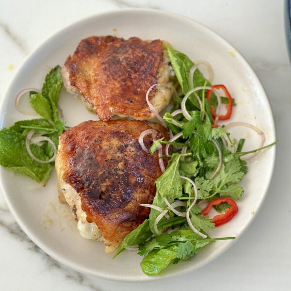 Crispy chicken things on white plate with herbs