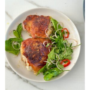 crispy chicken things on white plate with herbs