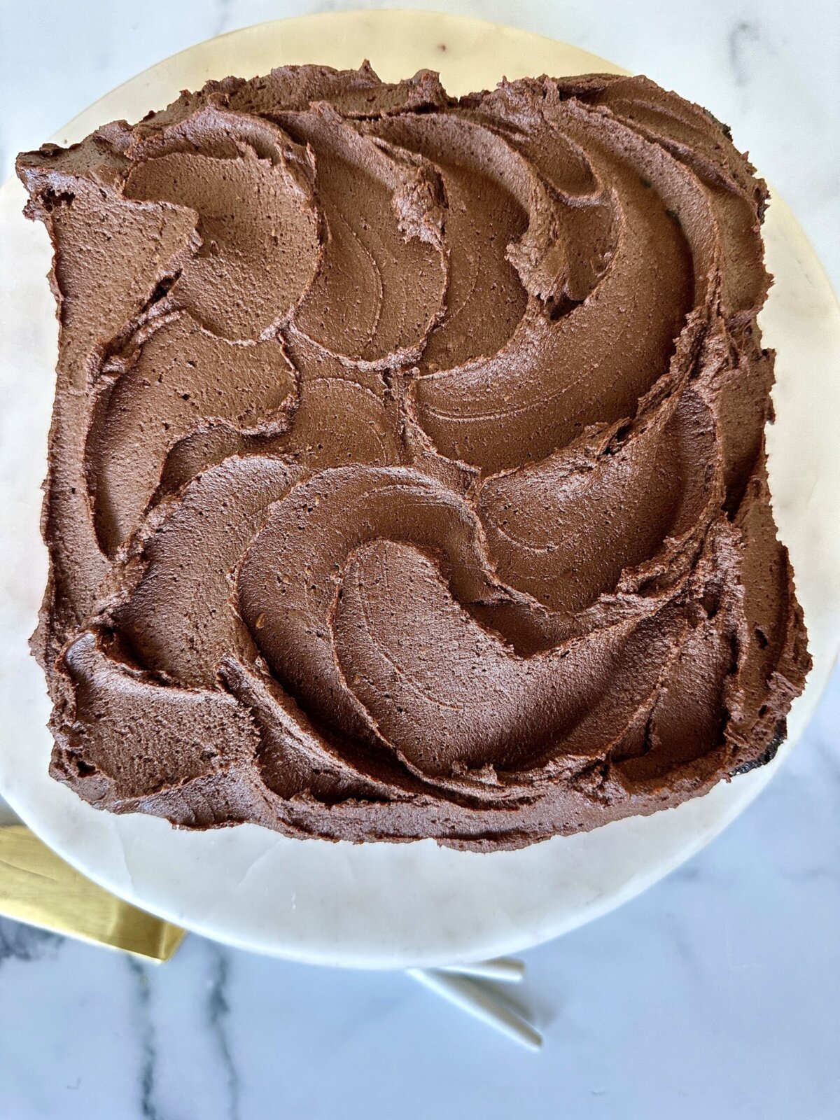 gluten-free vegan chocolate cake with sweet potato frosting on a cake stand