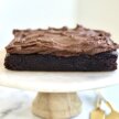 sweet potato frosting spread on top of a gluten-free vegan chocolate cake