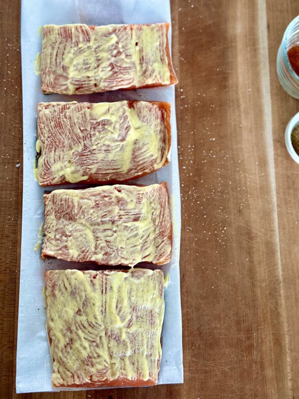 salmon on a lined baking sheet