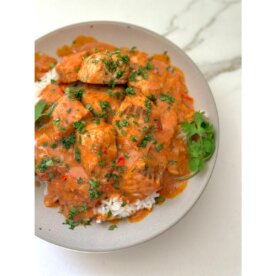 oven roasted salmon in a bowl with rice and sauce