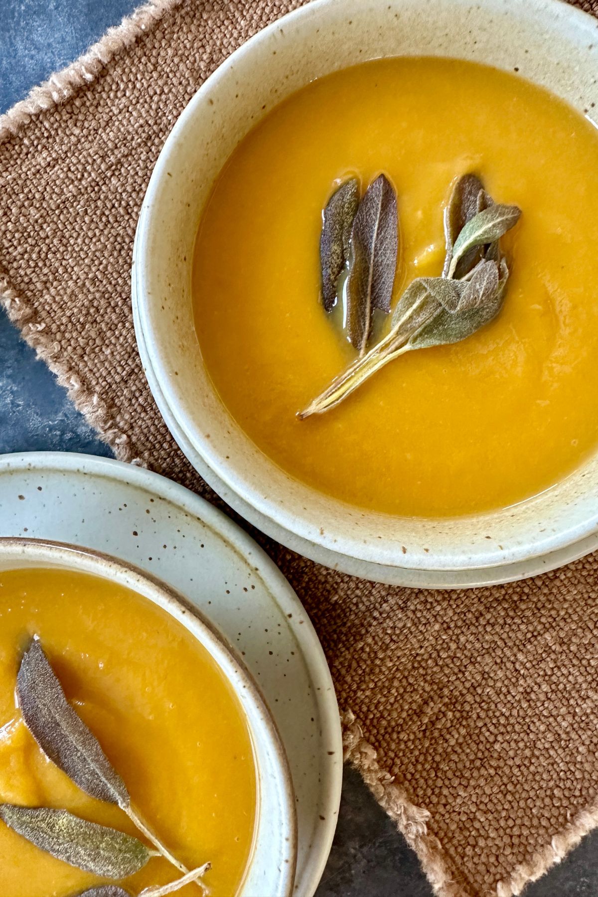 butternut squash and apple soup in two bowls 