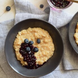 bowl of brown rice pudding with blueberries