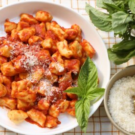 mashed potato gnocchi tossed in red sauce and topped with basil and parmesan cheese