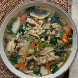 Bowl of mushroom barley soup with kale