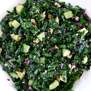 raw kale salad with citrus dressing in a bowl