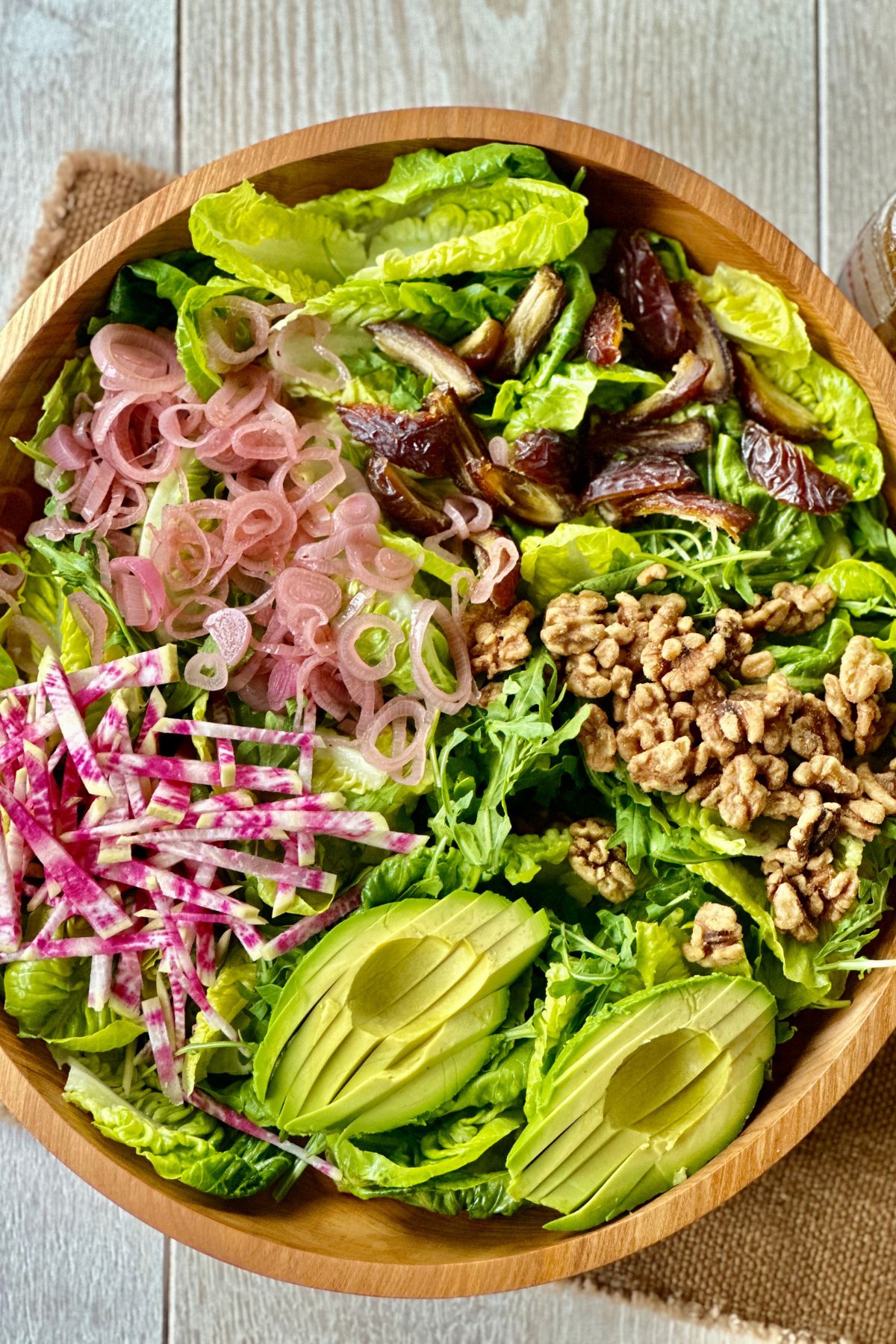 A photo of a thanksgiving salad tossed with homemade pomegranate vinaigrette