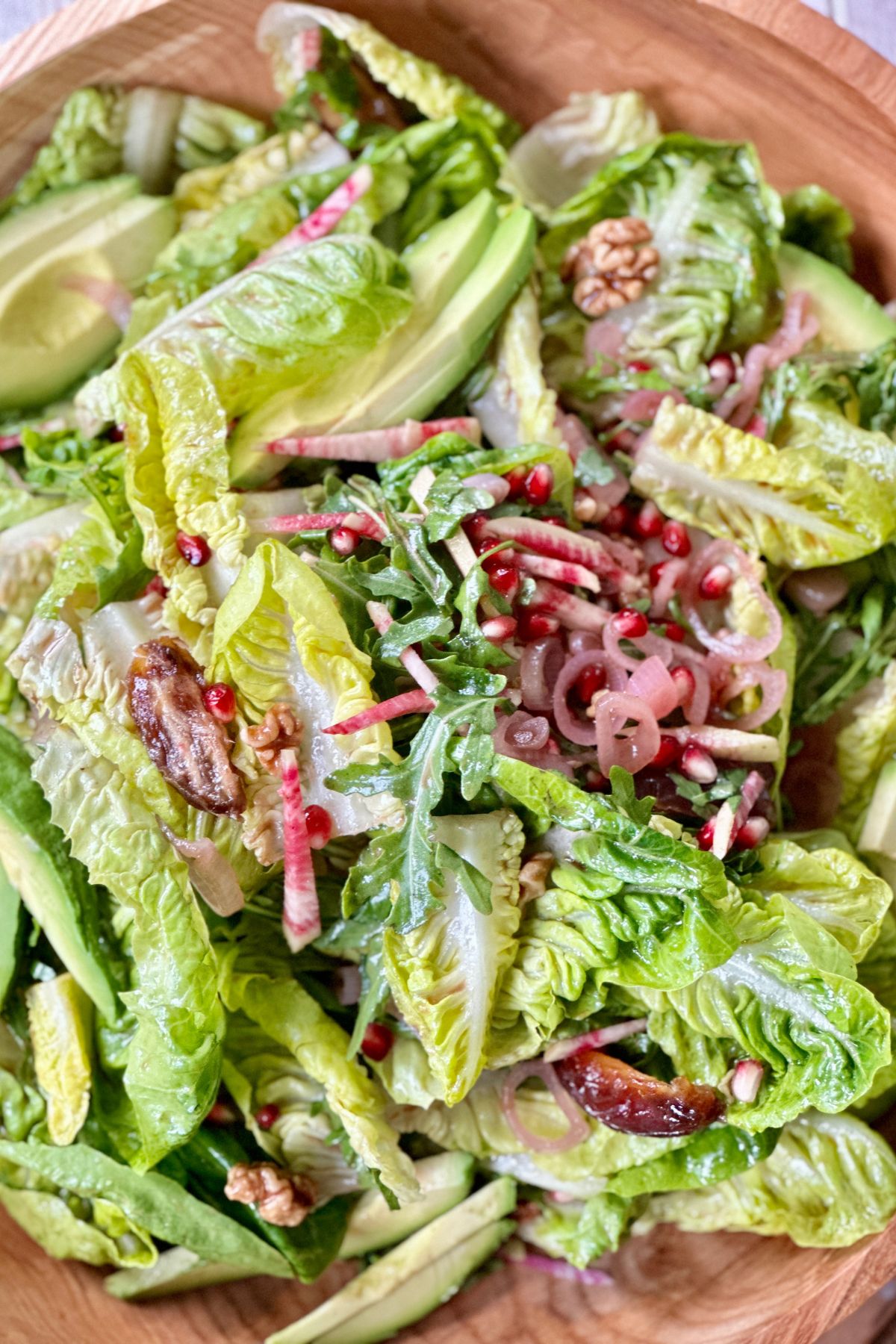 a close up of thanksgiving salad tossed in dressing