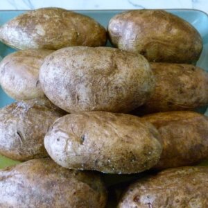 perfectly baked potatoes laying on a plate