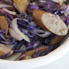 bowl of turkey sausages sliced with purple cabbage and fennel