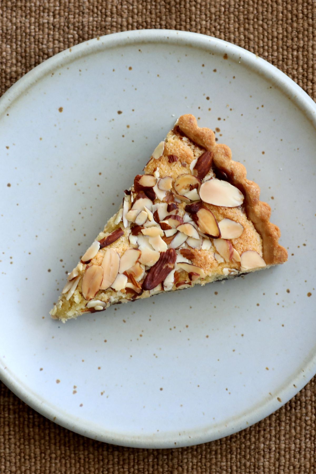 a slice of cherry bakewell tart on a plate