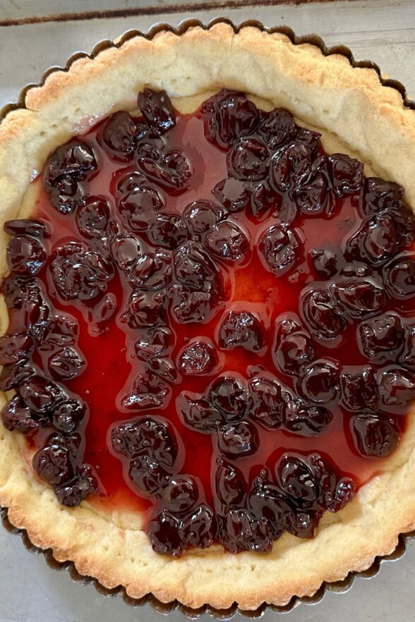 cherry jam spread onto the pie crust