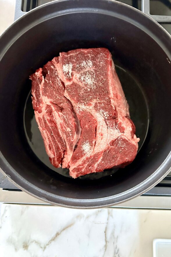 searing meat in a cast iron pan