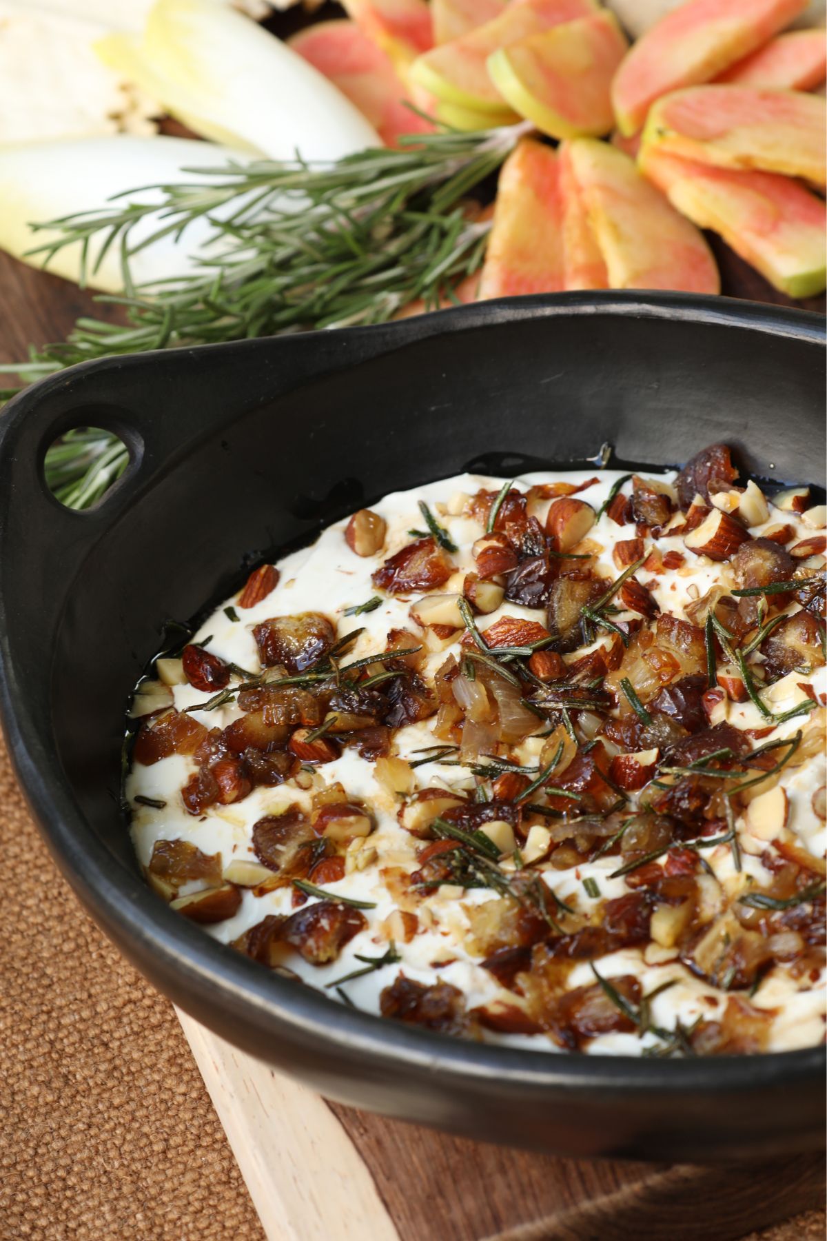 whipped goat cheese dip in a black serving bowl