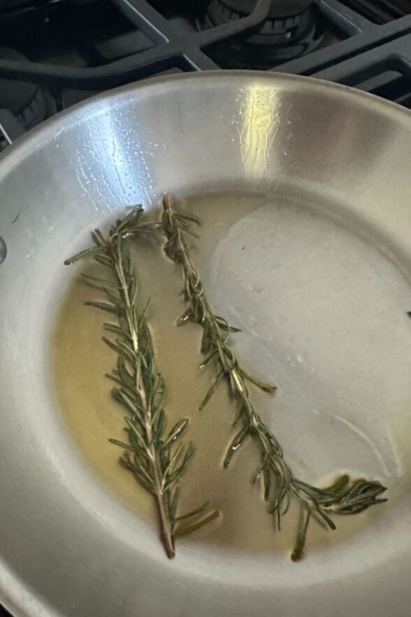 rosemary sprigs in a frying pan