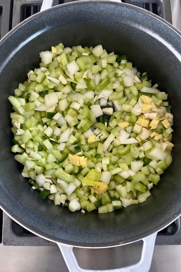 onion, celery, jalapeno, ginger and garlic sauteeing in the bottom of a soup pot