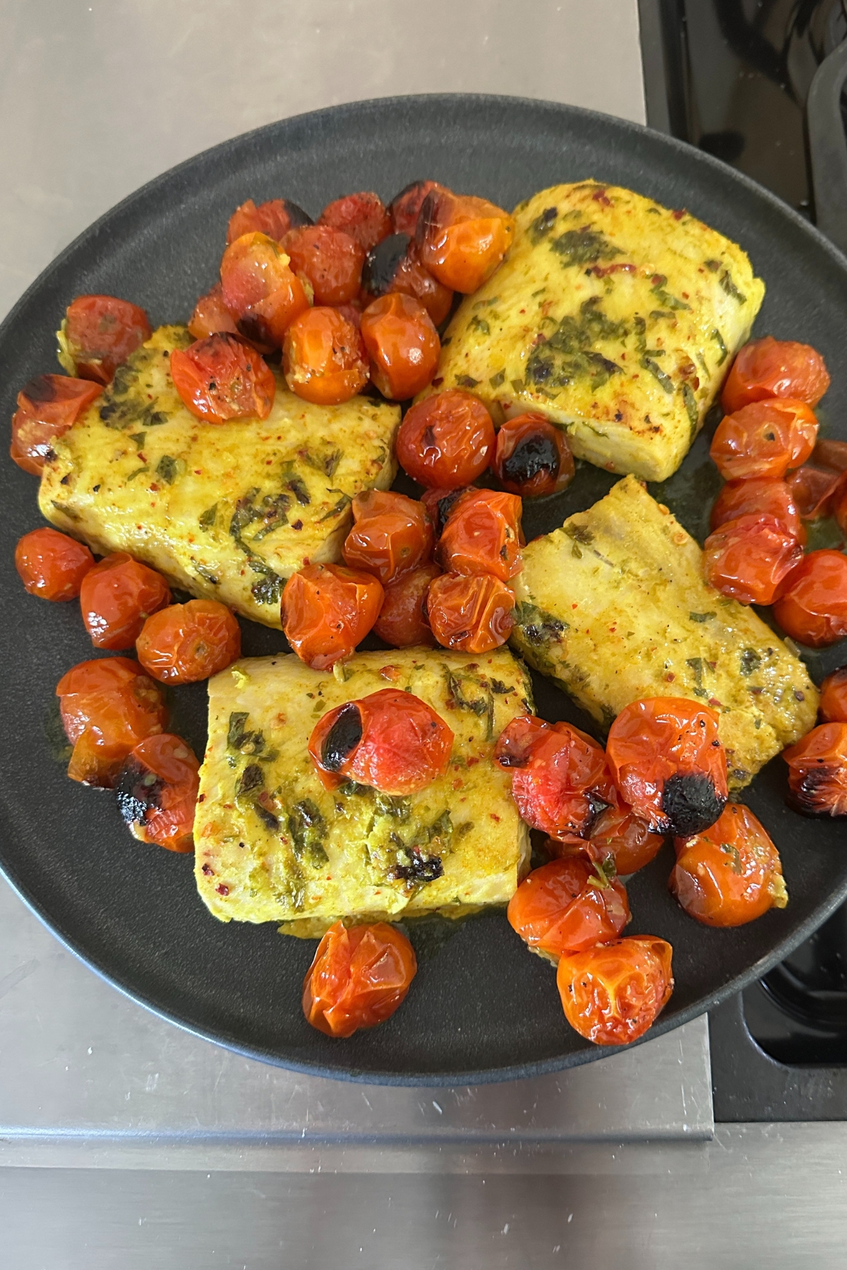 coconut fish and tomato bake on a serving plate 