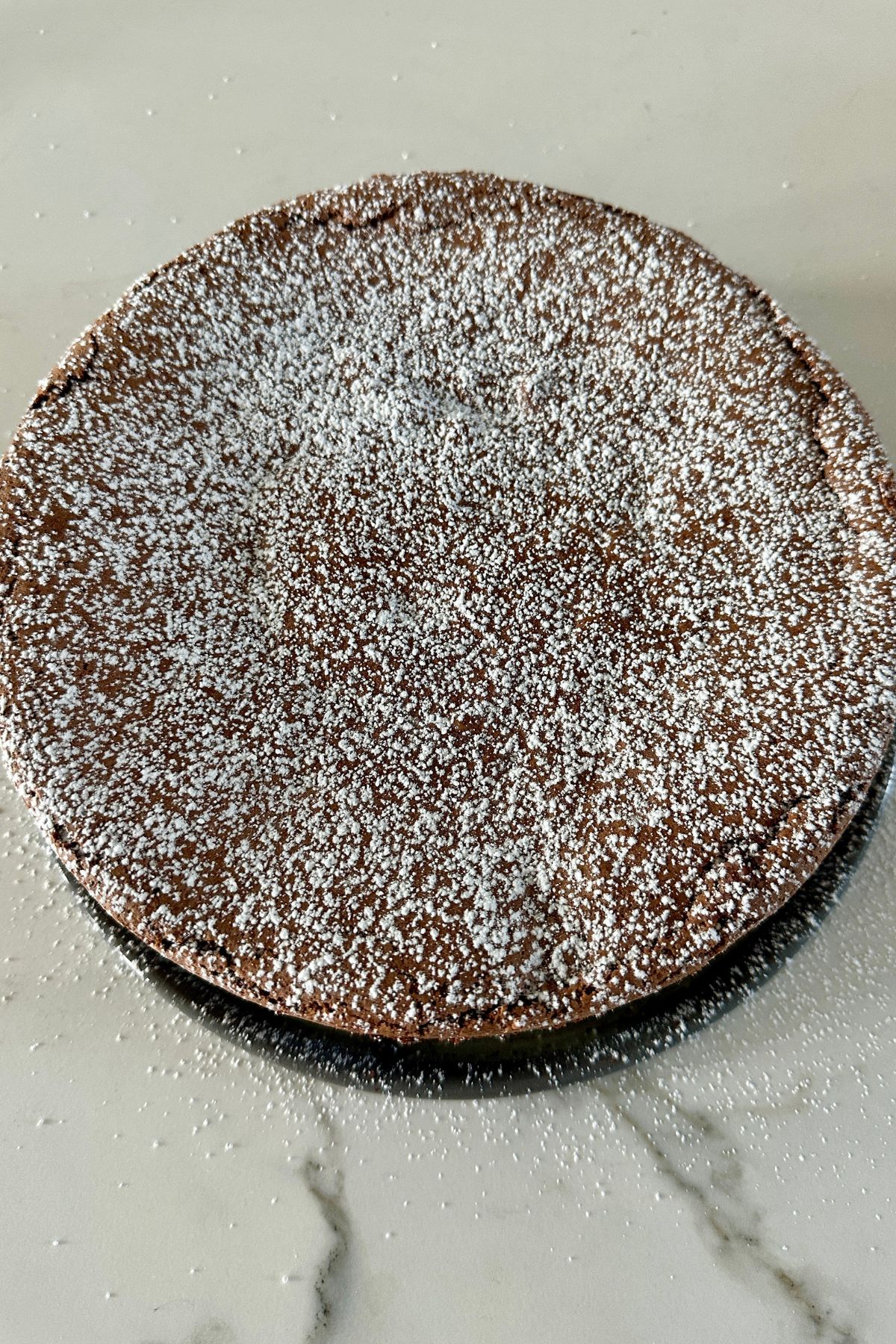 a baked chocolate cake on a white counter 