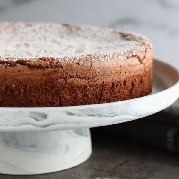 a torta caprese on a cake stand