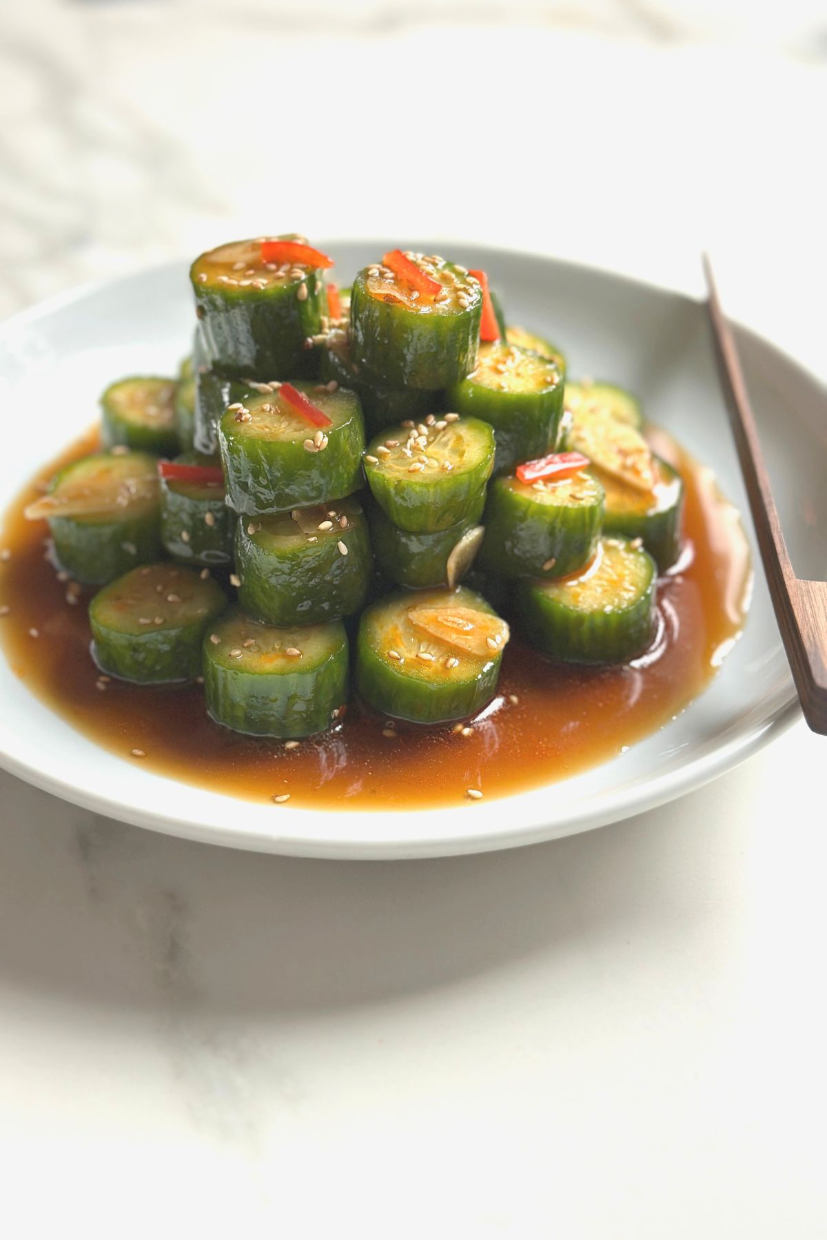 Stacked cucumber salad arranged in a shallow bowl, just like at Din Tai Fung.