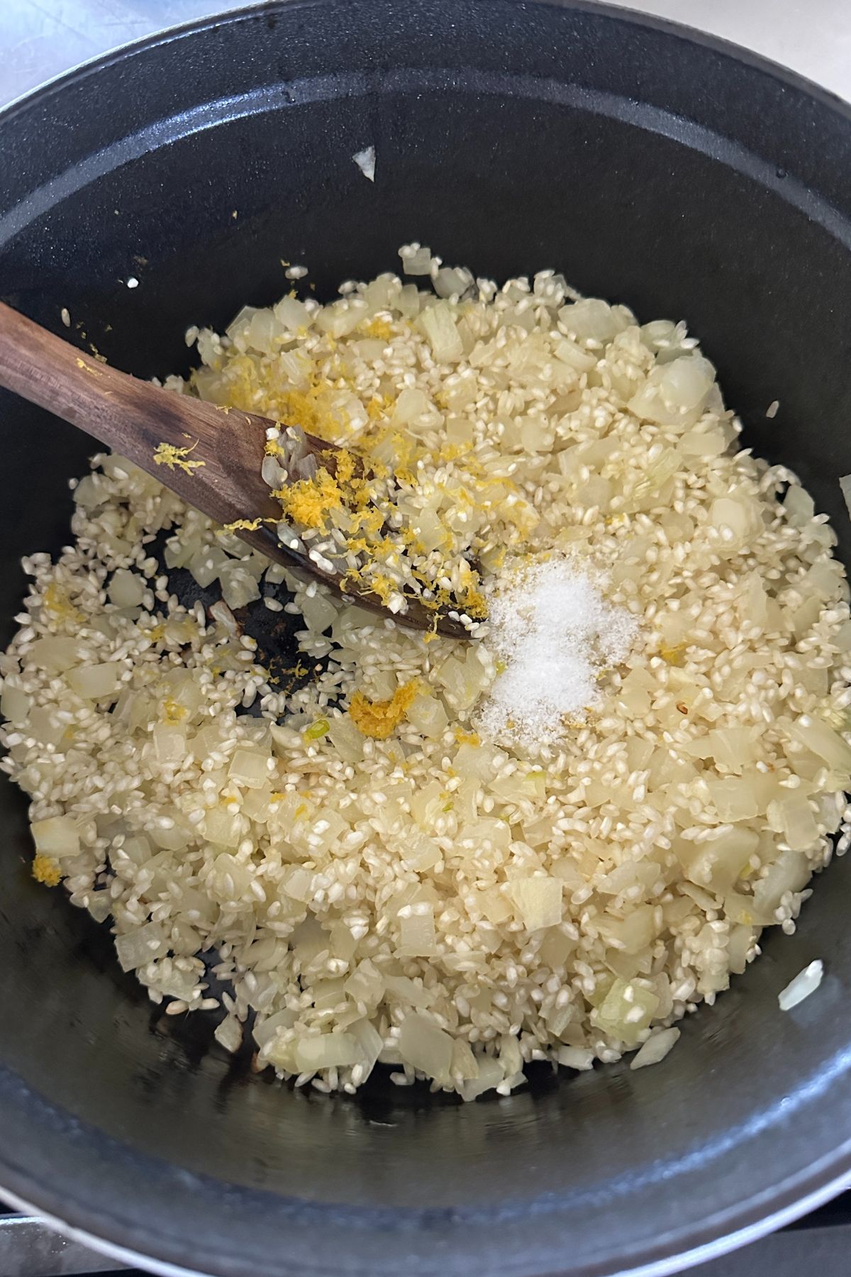 arborio rice and diced onions in a pot